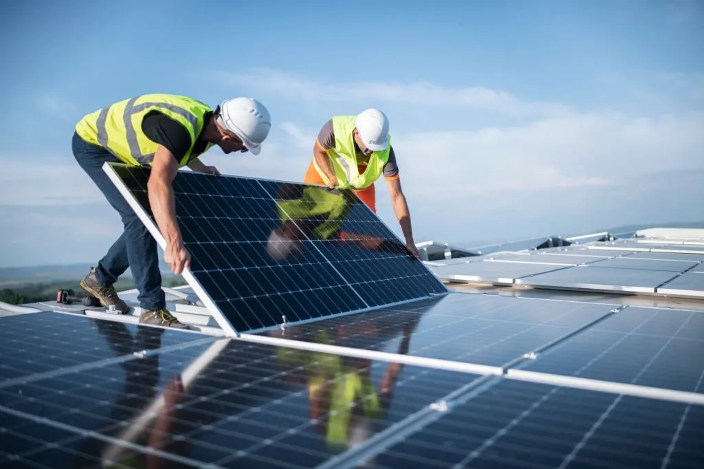 two worker adjusting their Solar Panels